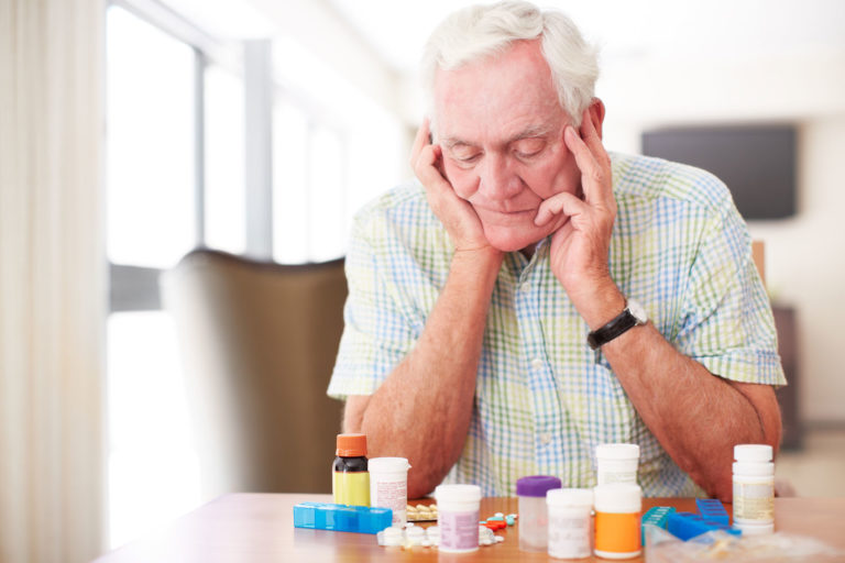 Man-Looking-at-Pills